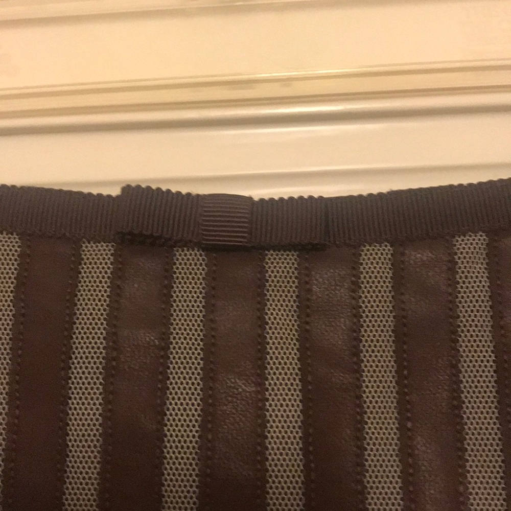 Mesh and leather-striped skirt.